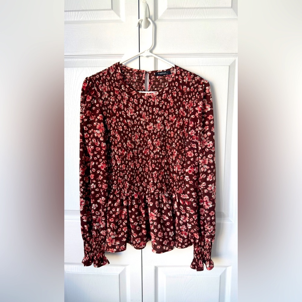 Fashion brand, burgundy floral top with cinched waist and wrists.